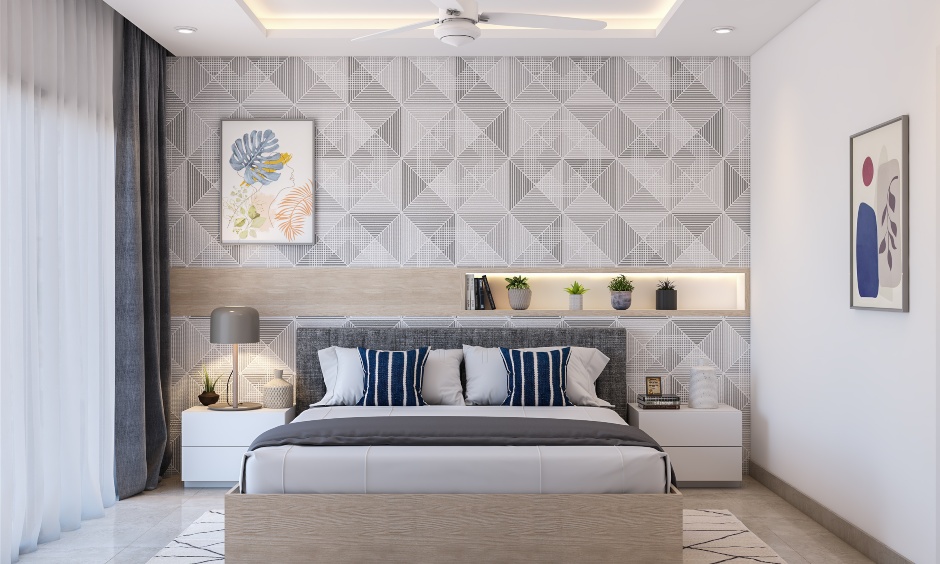 A 1 bedroom flat bedroom features geometric wallpaper and a bed with an upholstered headboard.