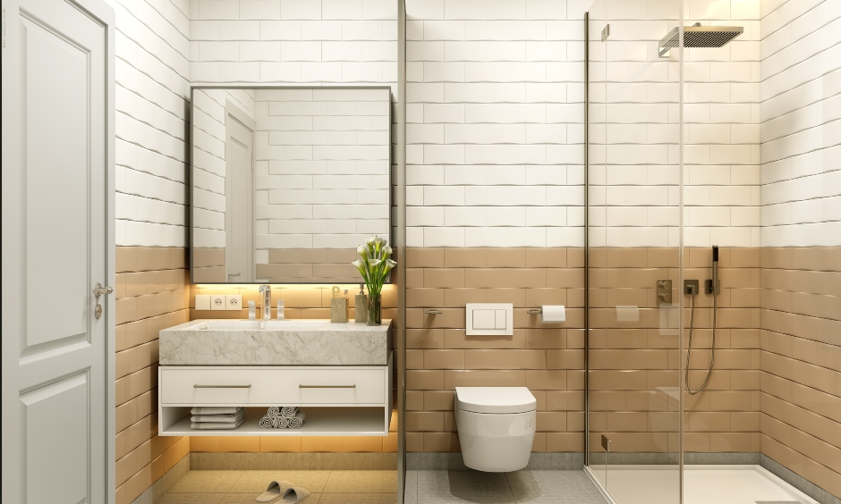 Bathroom in a 1bhk apartment with wall tiles and a glass partition
