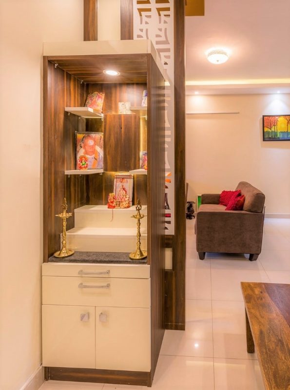 Small wooden mandir design with multiple Wooden shelves and drawer storage for apartments