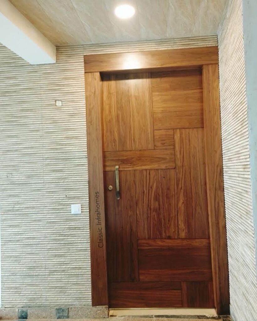wooden panelling on Safety door interior design in 3bhk apartment greater value sarnam in noida.jpg