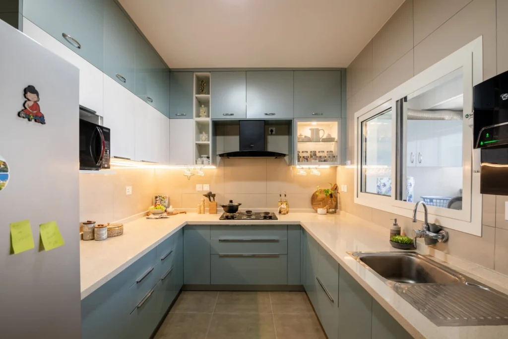 Glossy Blue & White Modular Kitchen in Noida – Calm, Compact & Contemporary
