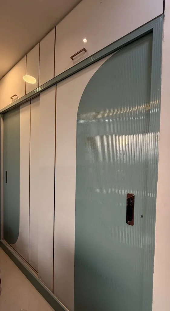 Modern Sliding Wardrobe with Curved Glass Panels & Gold Accents Stylish Bedroom Storage