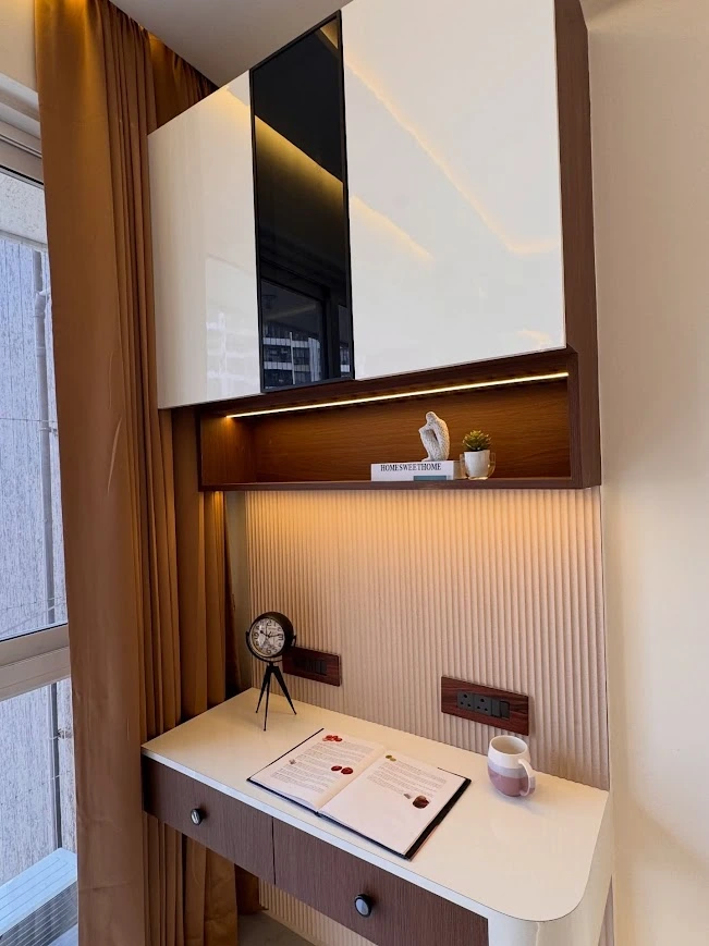 A Compact Study Nook with Overhead Storage and Warm Lighting