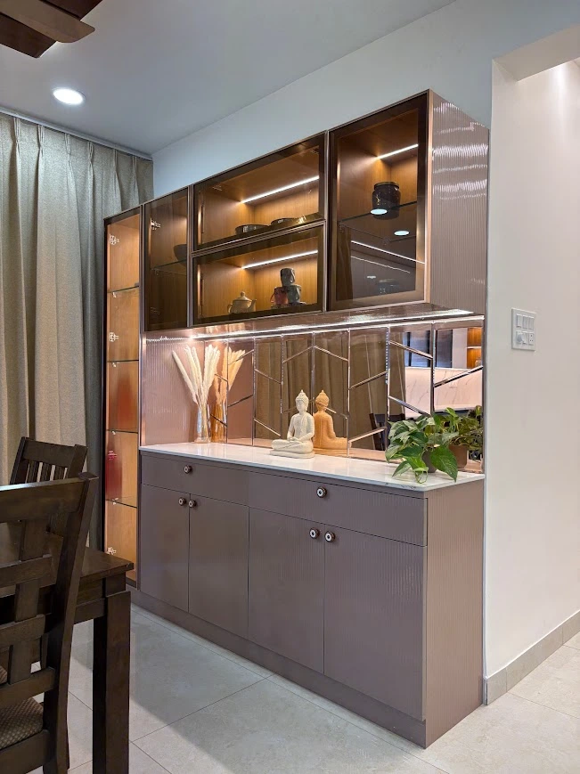 A Premium Crockery Unit with Glass Cabinets, Mirror Back Panel and Warm Lighting