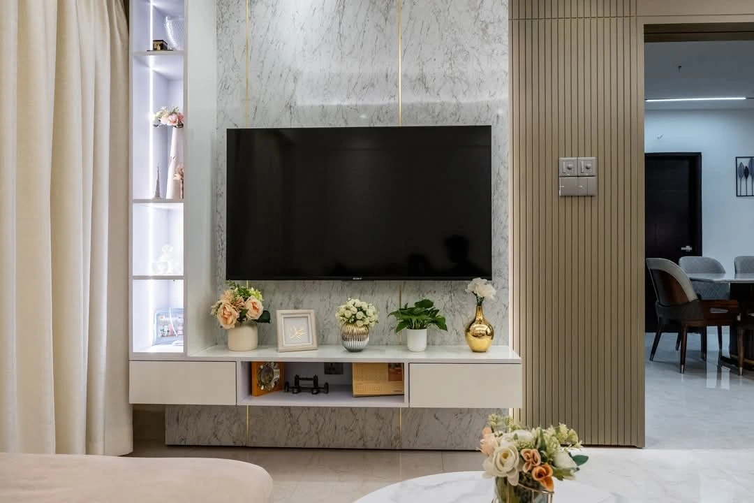 A Soft Elegant TV Unit with Marble Backdrop and Display Niche