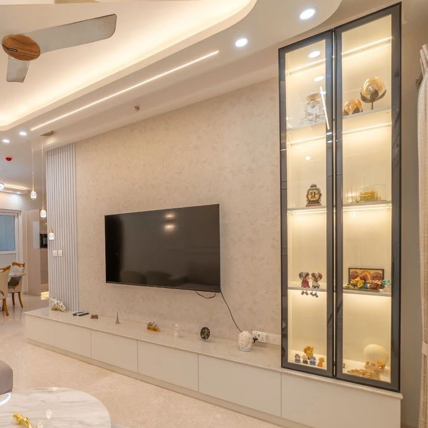 A Spacious TV Unit Design with Glass Display Cabinet and Soft Ambient Lighting