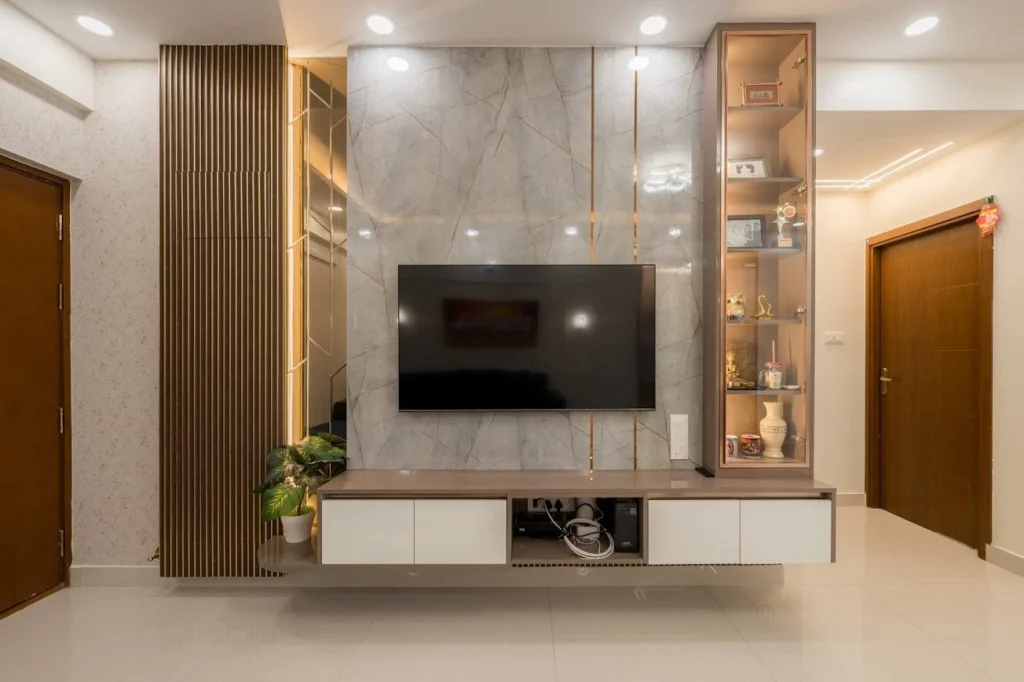 A Premium TV Unit Design with Marble Finish and Warm Display Lighting
