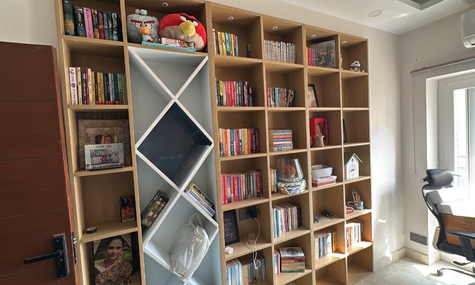 Full-height custom bookshelf with geometric centre display by interior designer in Sector 168 Noida