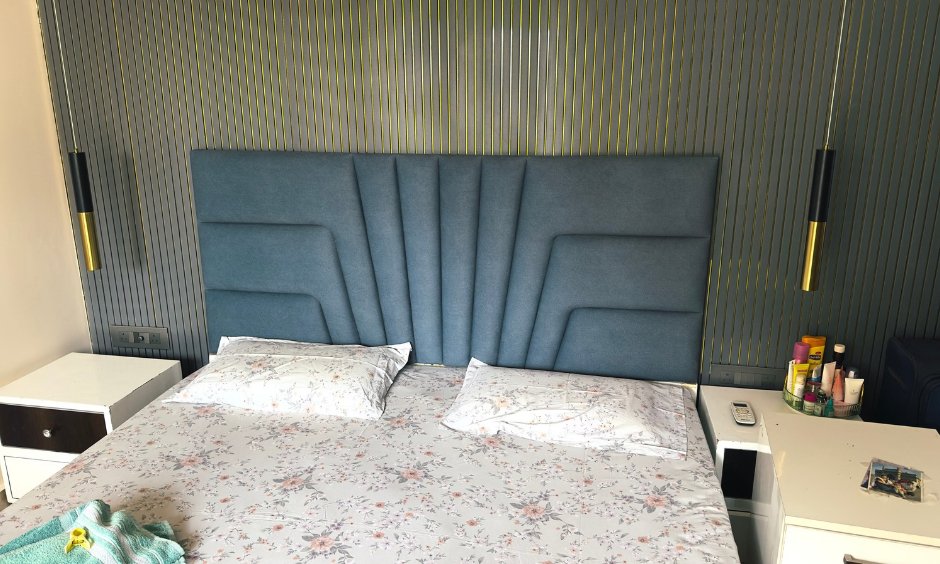 Vertical wall panelling behind an upholstered bed